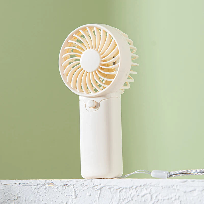 Small Fan + Handheld + Portable with Wrist Strap + Requires AAA Batteries + 1 Speed Setting + Cross-Border Bestseller